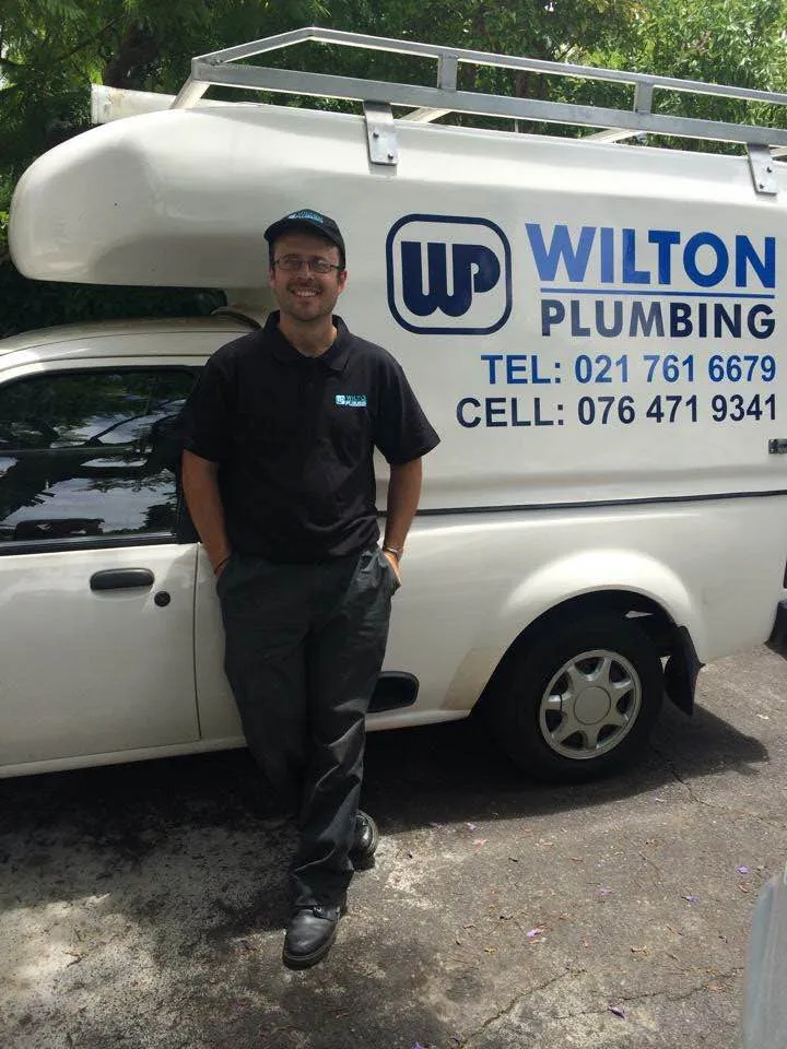 David Wilton standing beside a Wilton Plumbing van.