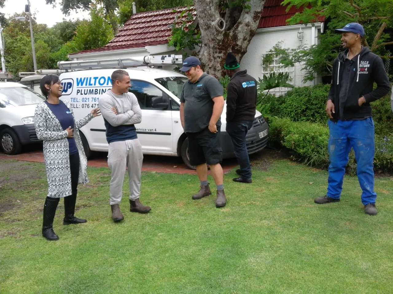 The Wilton Plumbing team photographed together on a lawn.